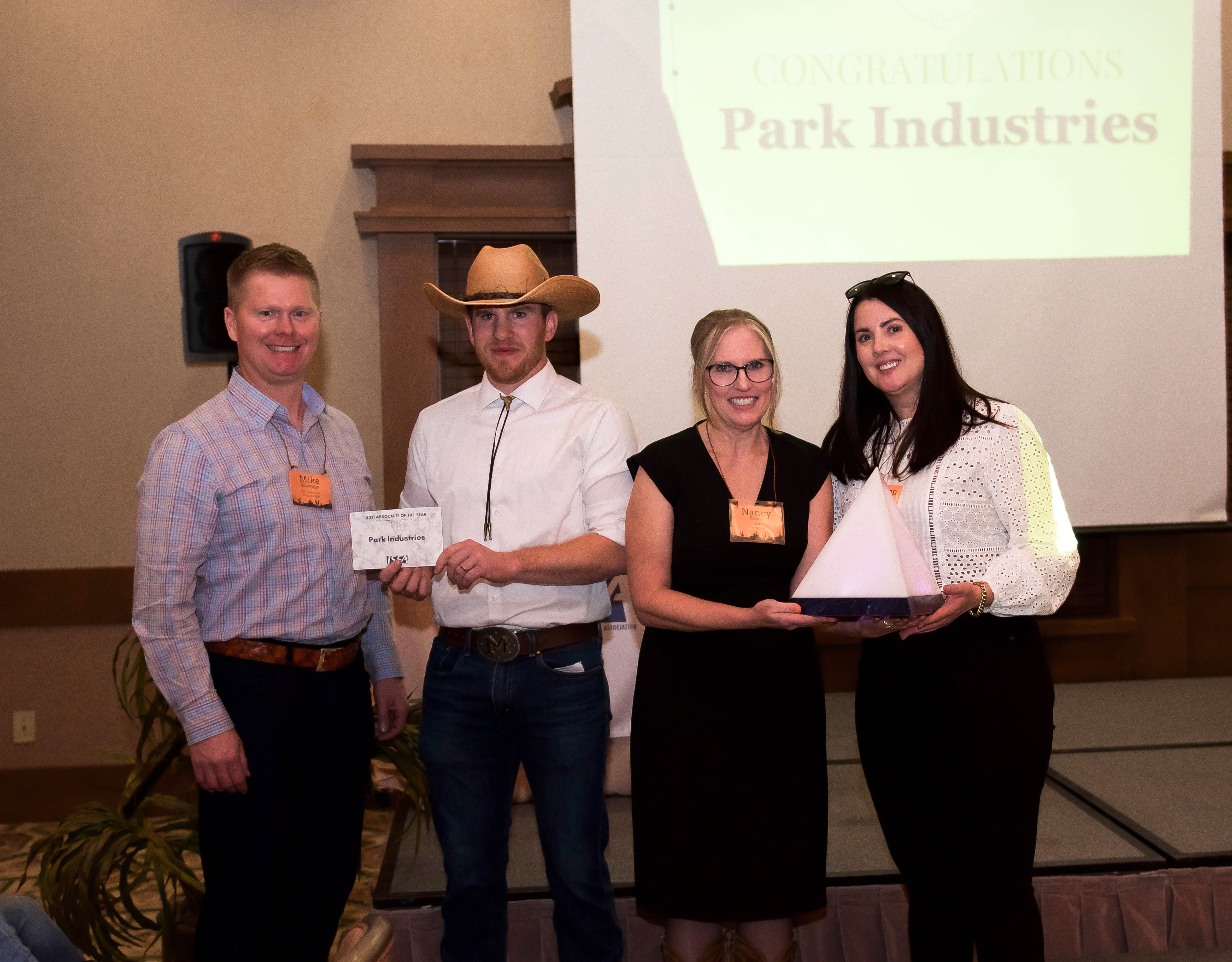 Meagan Hegland and Mike Schlough of Park Industries were presented with the 2021 Associate of the Year Award by Nancy Busch, executive director, and Travis McDermott, McDermott Top Shop.