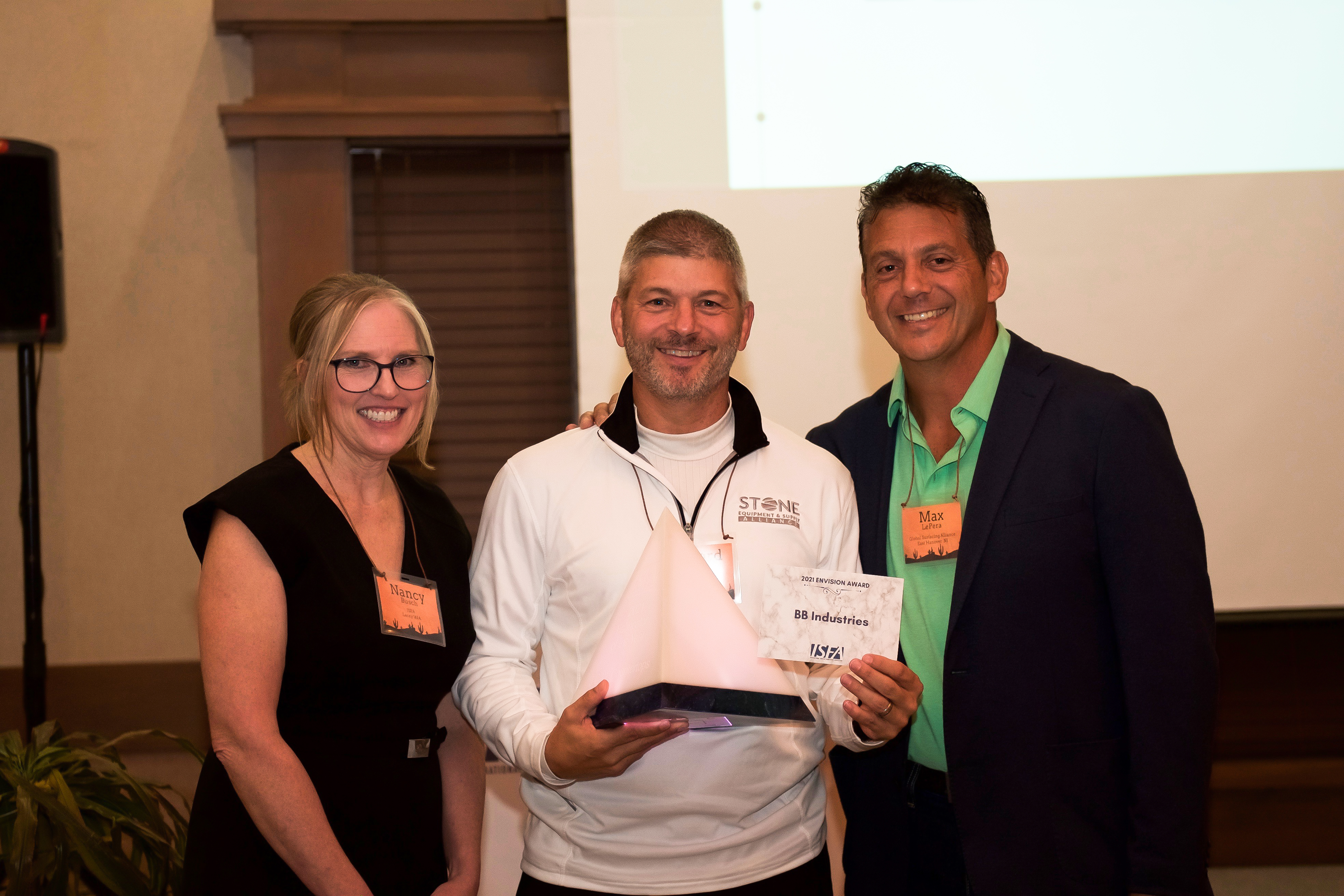 Rick Stimac, BB Industries, accepts the 2021 Envision Award from Nancy Busch, executive director, and Nancy Busch and Paul "Max" Le Pera, director at the ISFA Annual Conference. 
