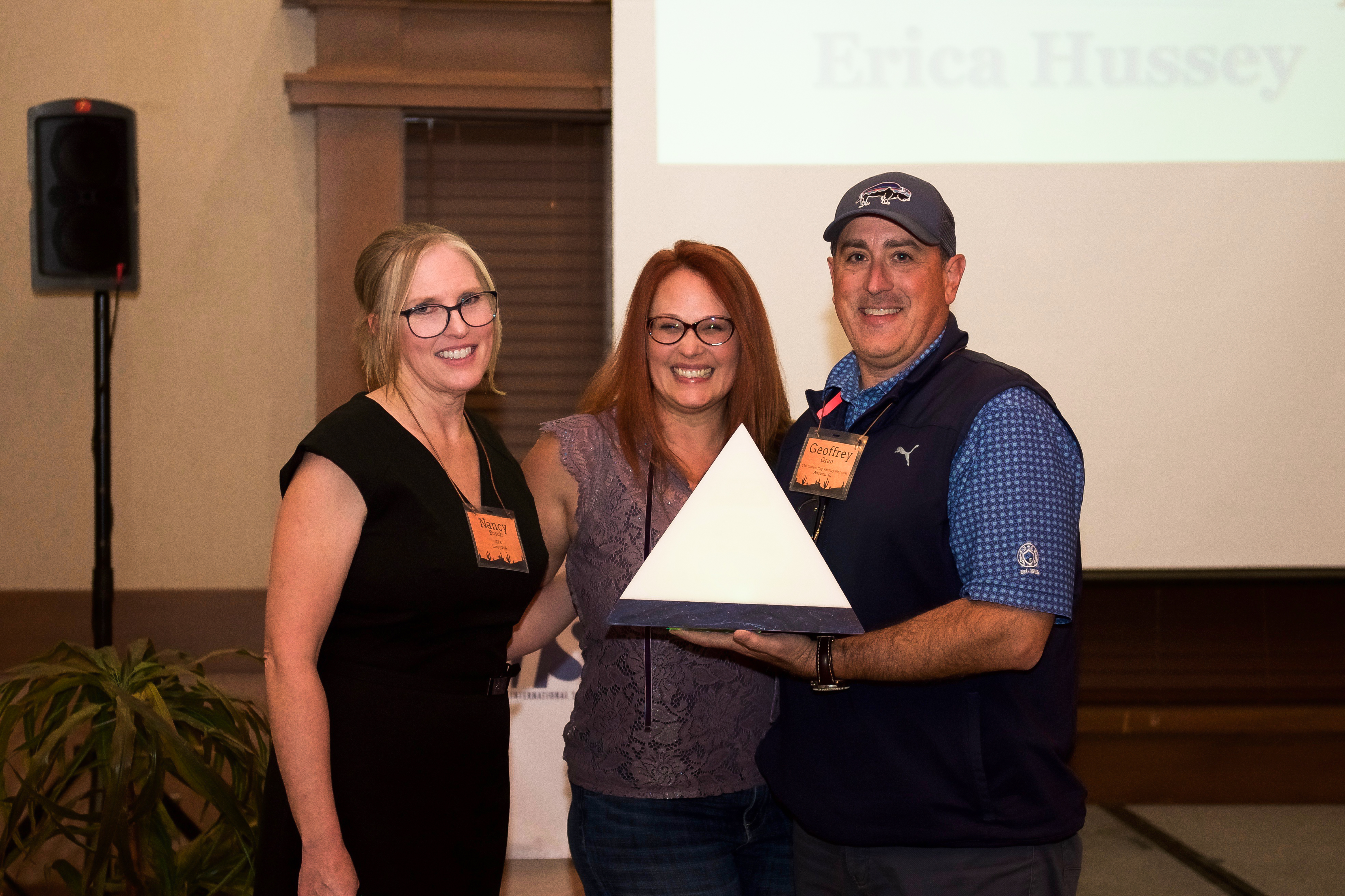 Nancy Busch, executive director, and Geoffrey Gran, The Countertop Factory Midwest and 2020 Fabricator of the Year Award winner, present Erica Hussey of J.C.W. Countertops with the 2021 Fabricator of the Year Award.